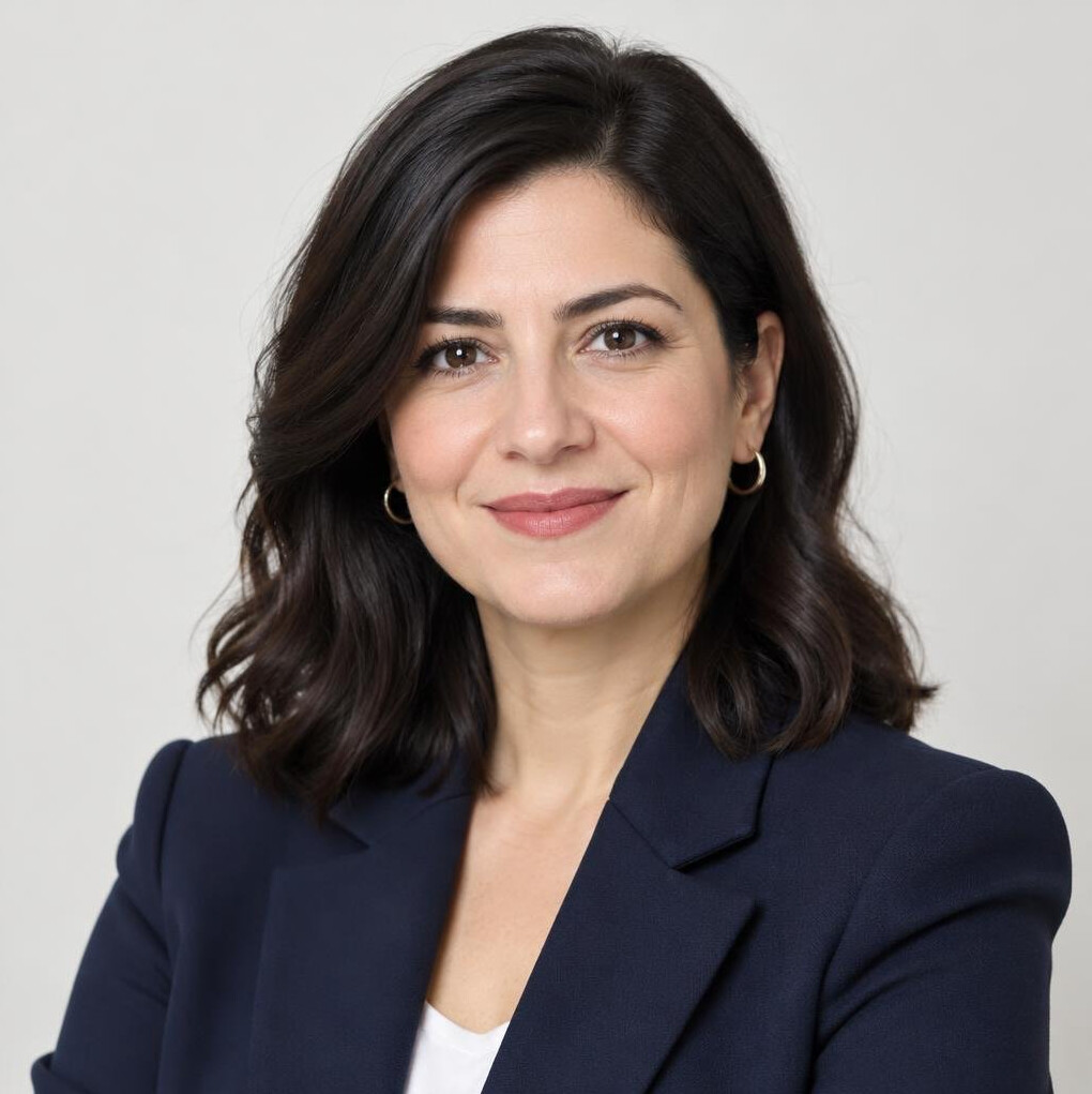 Portrait of a smiling Turkish woman editor in a blazer